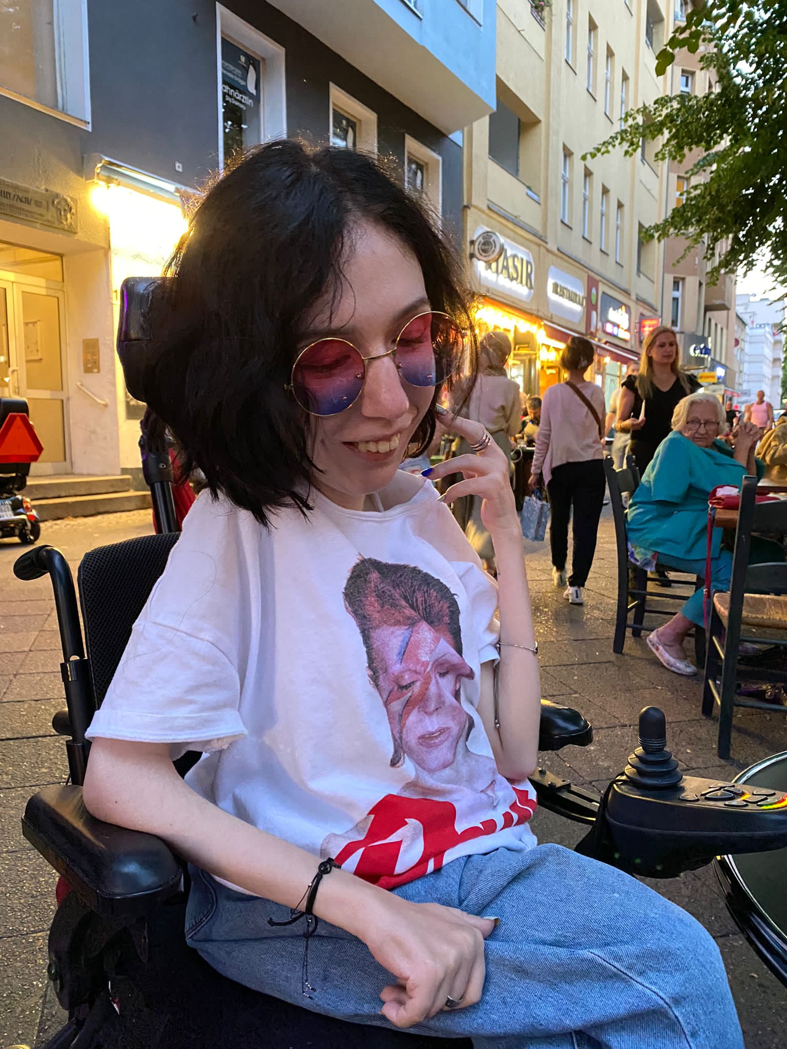 a brown dog sitting on top of a sandy beach