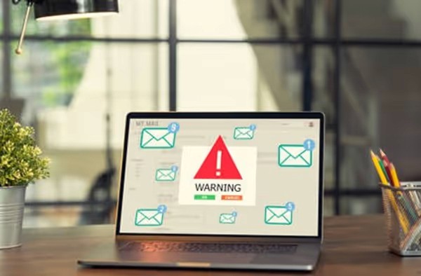 Red digital warning symbol glowing on a circuit board interface, representing active ransomware exploitation of the VMware ESXi CVE 2025 22225 vulnerability and hypervisor compromise.