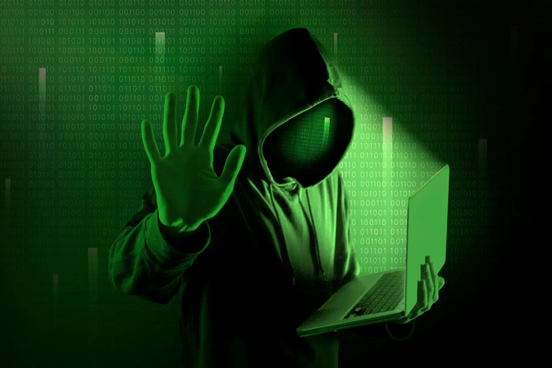 A hooded figure against green binary code representing organized crime rings weaponizing AI to target social commerce platforms.