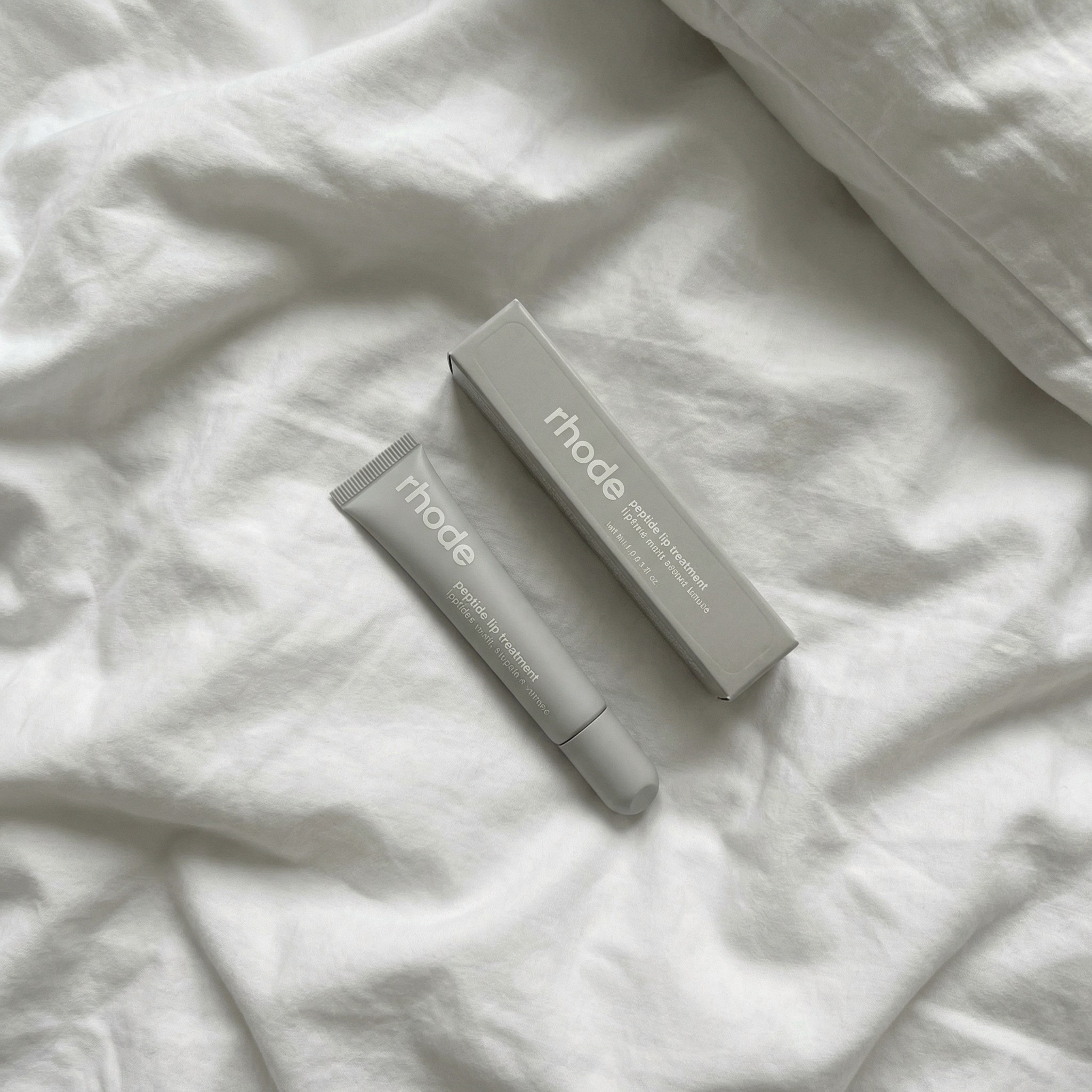 A serene spa setting with two lounge chairs beside a warm, reflective pool and soft, natural lighting.