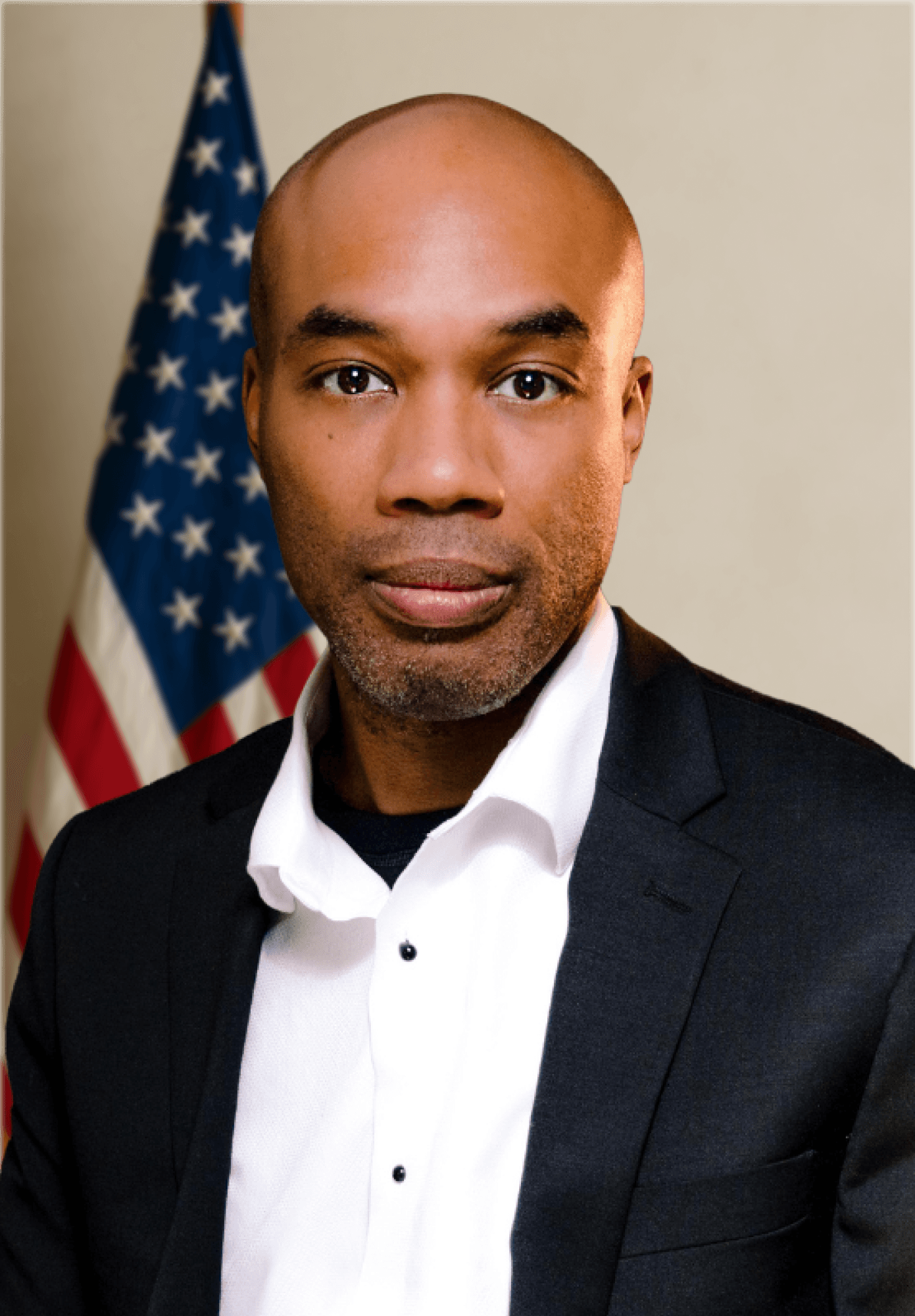 man sitting facing silver MacBook inside room