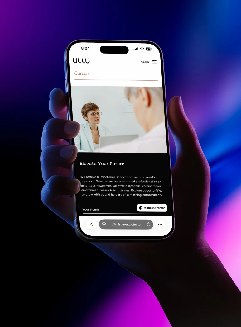 A designed website displayed on a tablet held in two hands