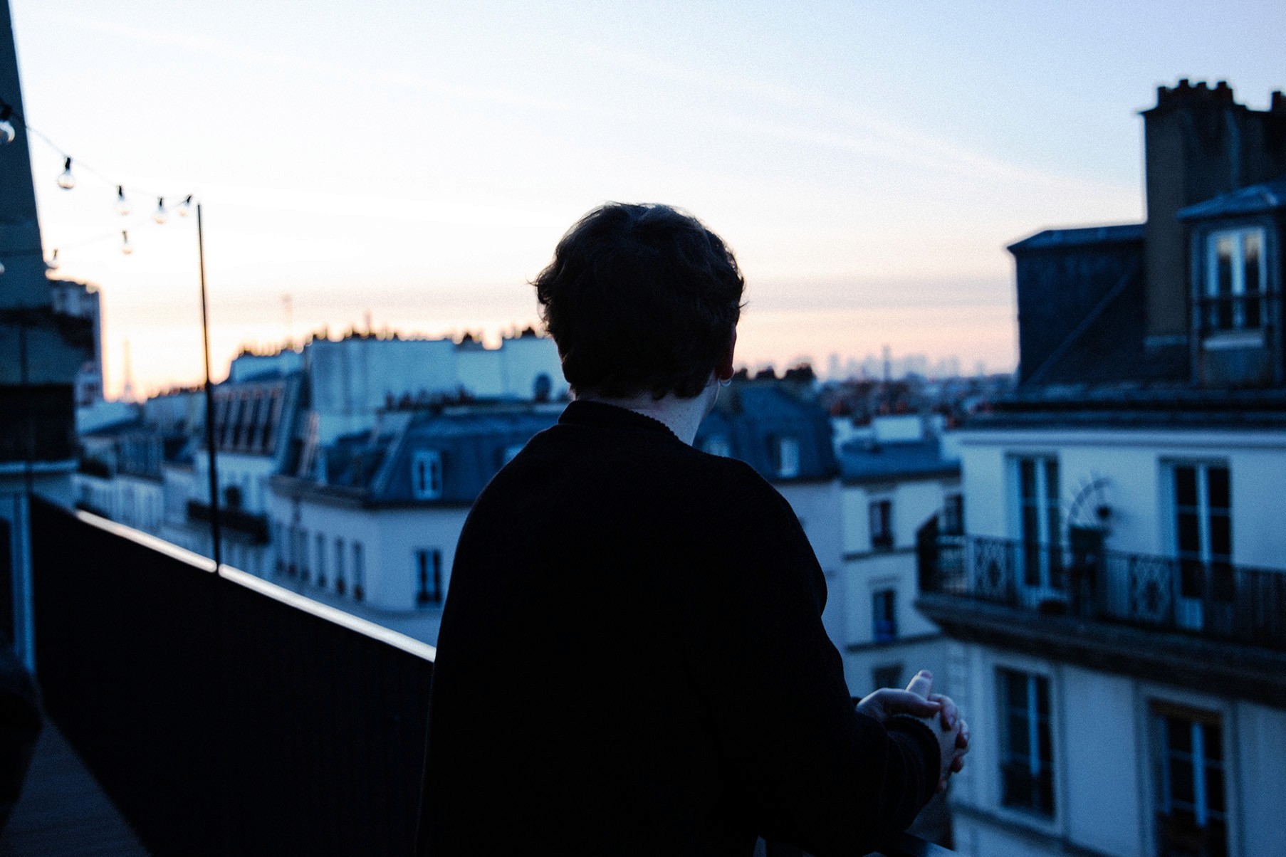 Black and white image of people working at a table with laptops, showing hands gesturing during discussion of digital content displayed on screens, with fabrica® logo in the corner.