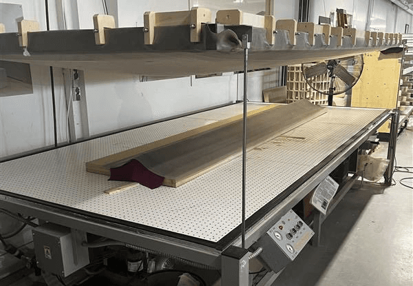 Corian is a popular plastic product used frequently in commercial spaces because its versatile and durable. To achieve a uniform curve production heated the corian sheet and laid it over the CNC’d mold, removed all the air.