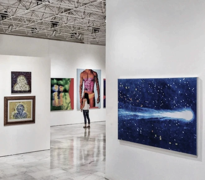 Woman in gallery with colorful paintings