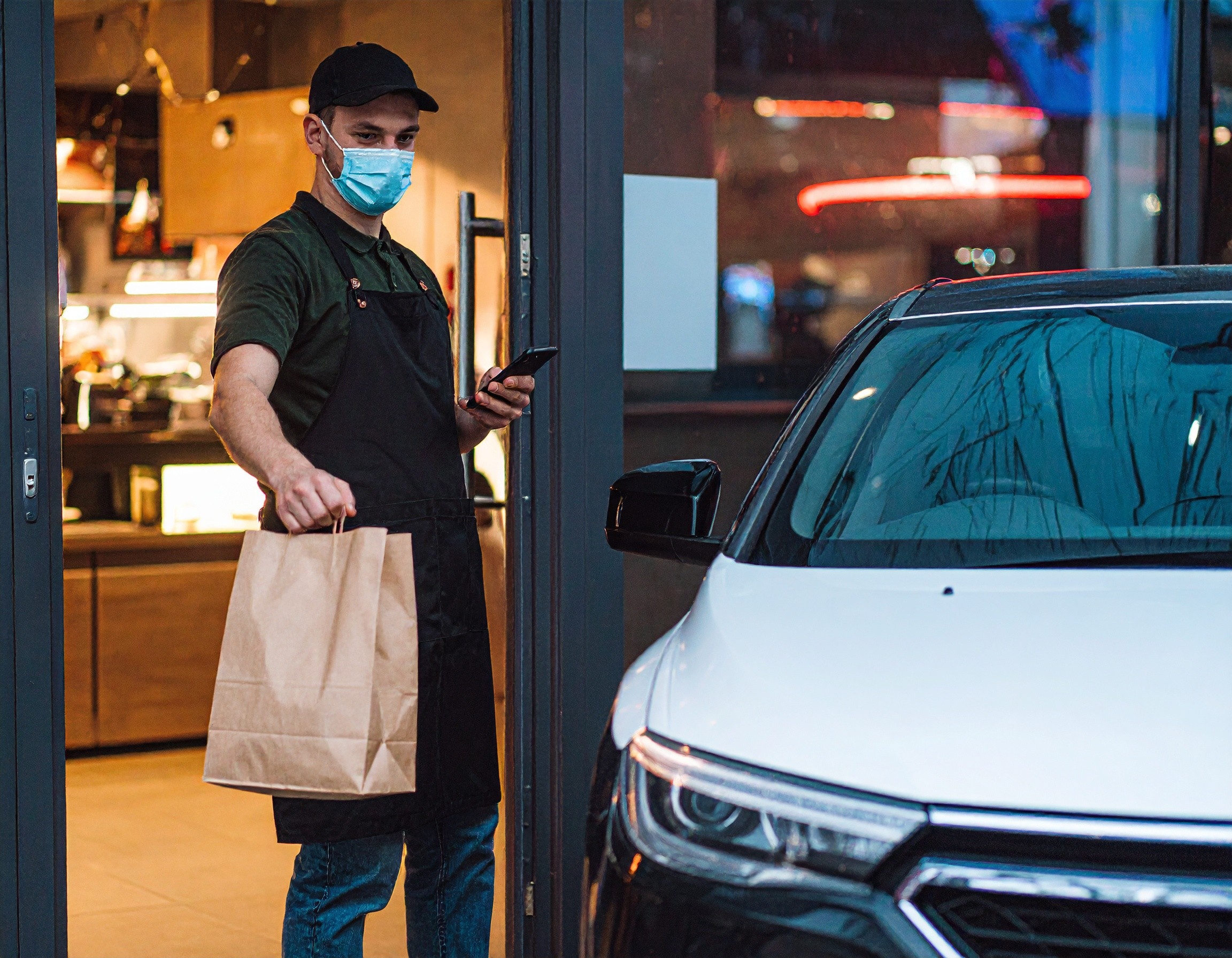 worker bringing bag out to car