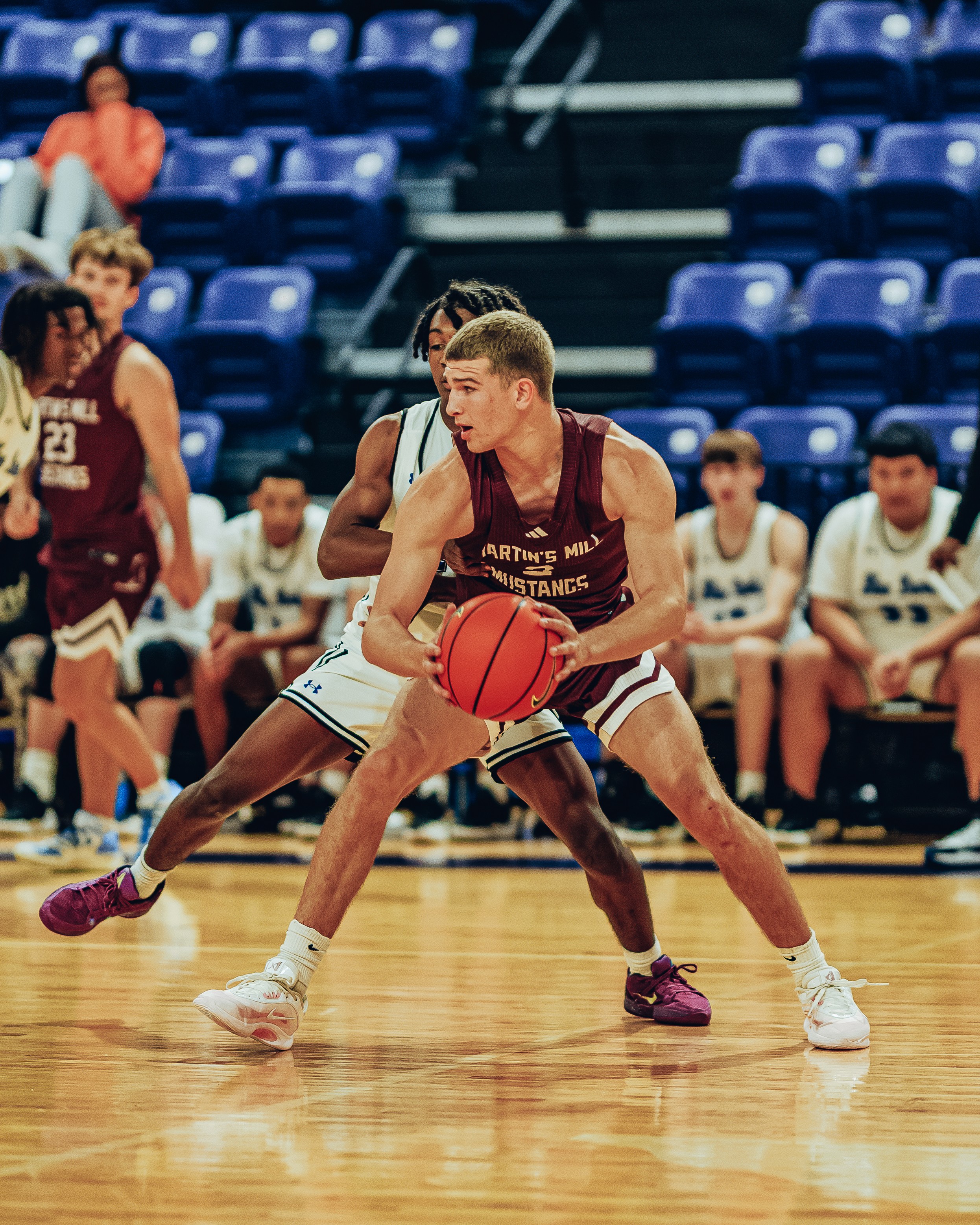 Three people sitting on a couch in a room looking at mobile devices
