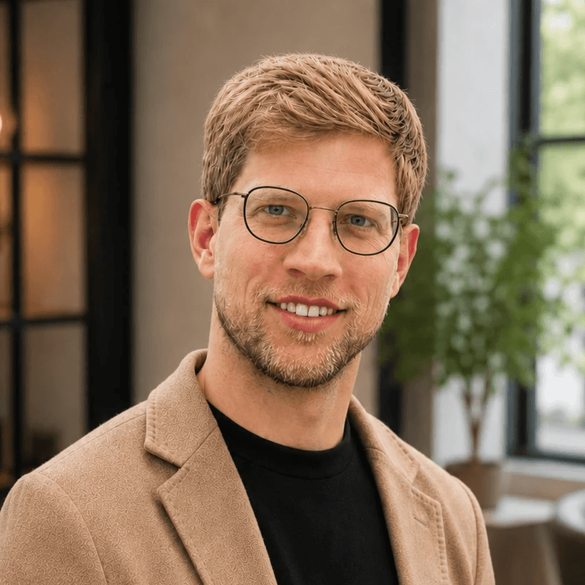 Headshot of man with short blonde hair, a short beard, and glasses