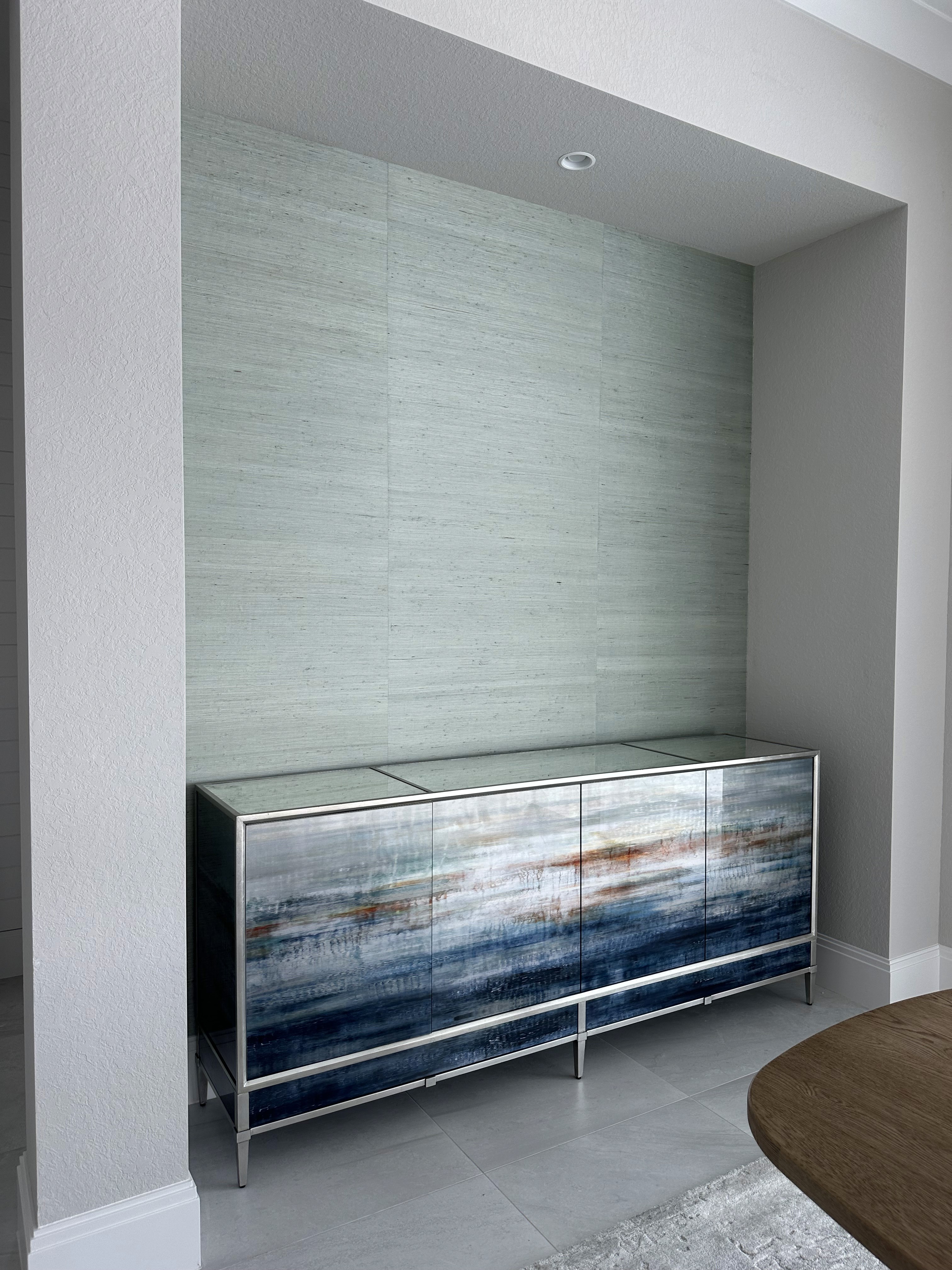 Textured grasscloth wallpaper installation in a luxury suite