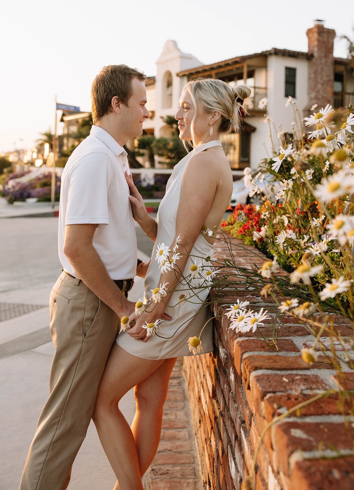 A couple stands closely in an intimate embrace.