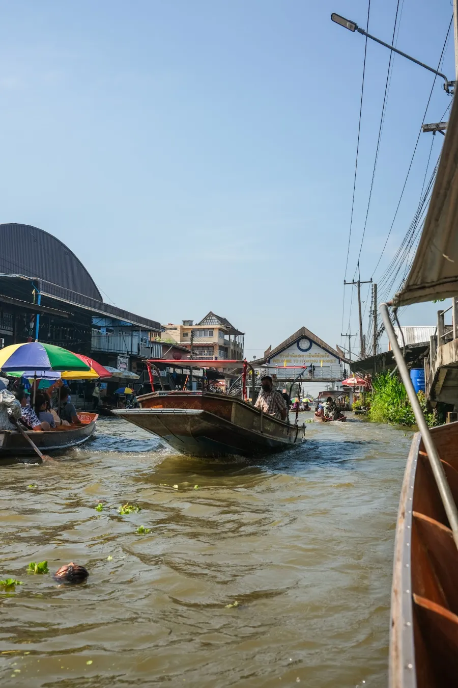 Longtail boats on the busy canal waterway at Damnoen Saduak floating market, Thailand