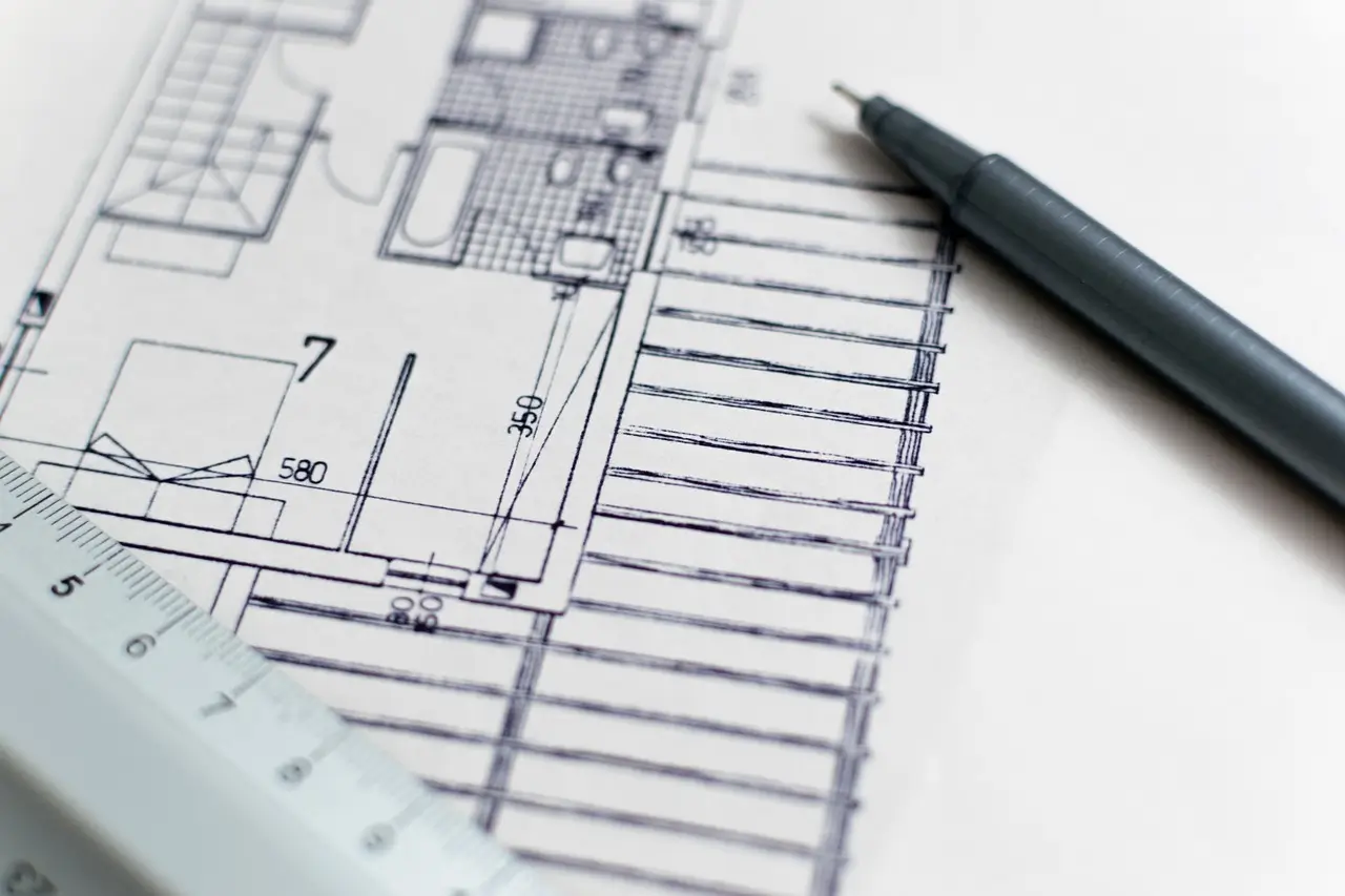 A sketch of a new home design with a ruler and pencil