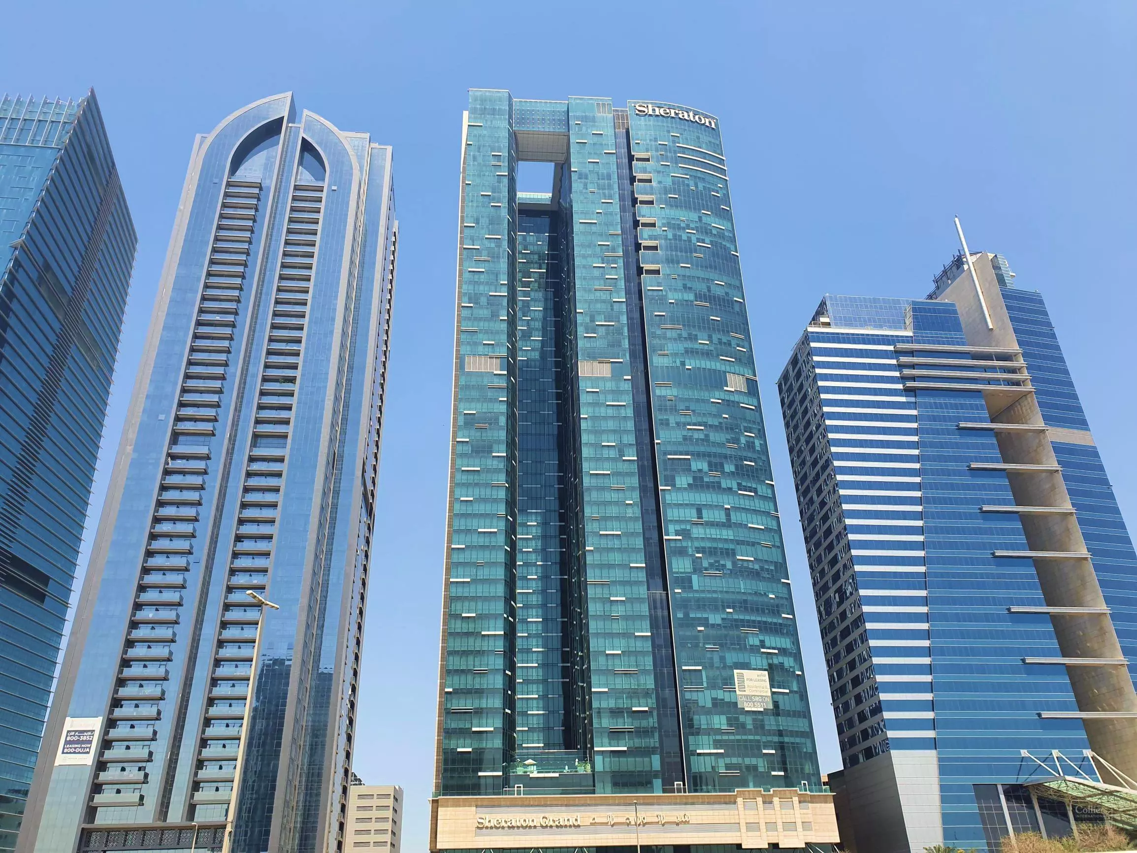 Wide exterior view of Burj Al Salam towers in Dubai, showcasing premium real estate listings and modern architecture.