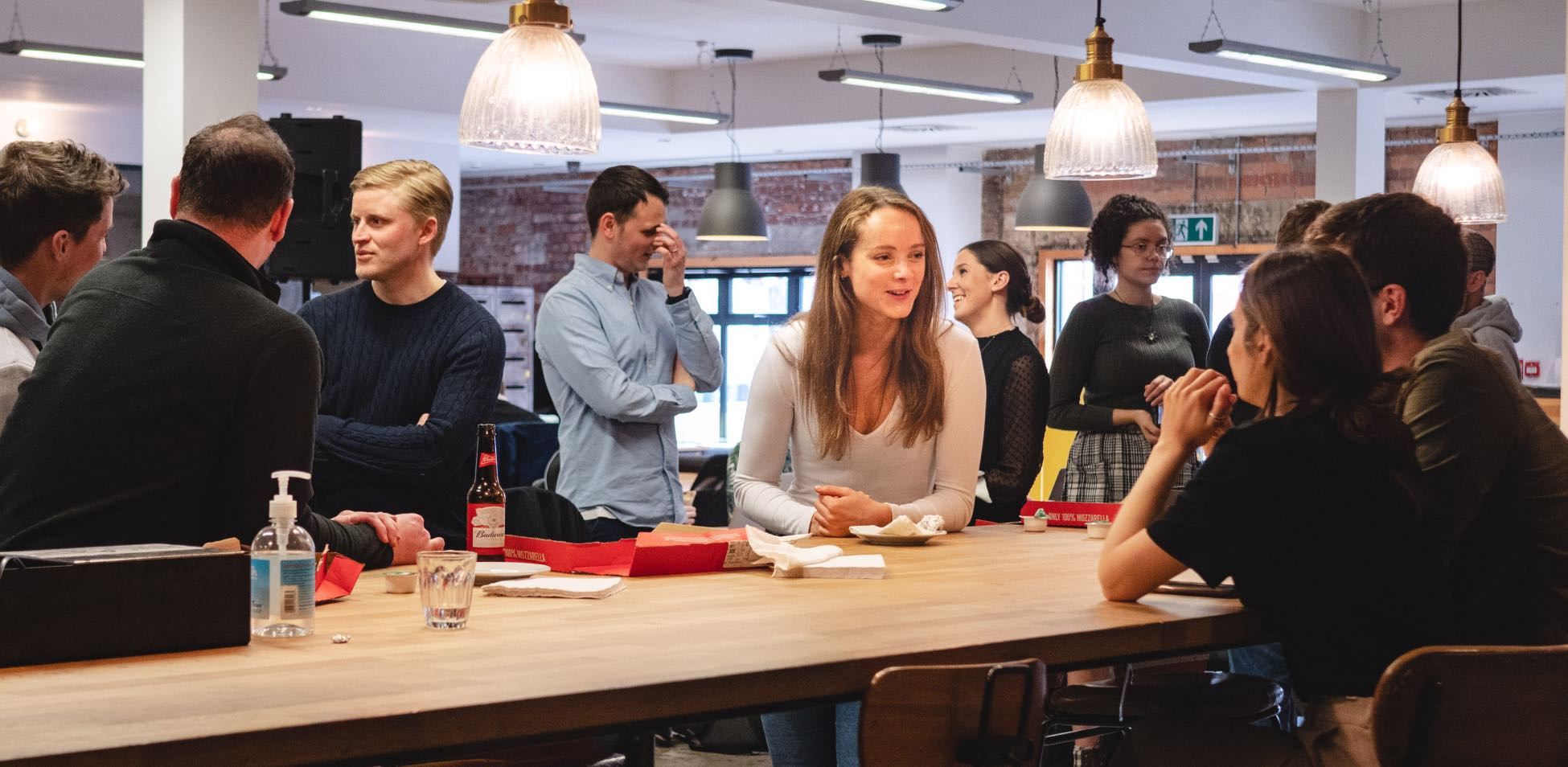 People talking and enjoying drinks at a table.