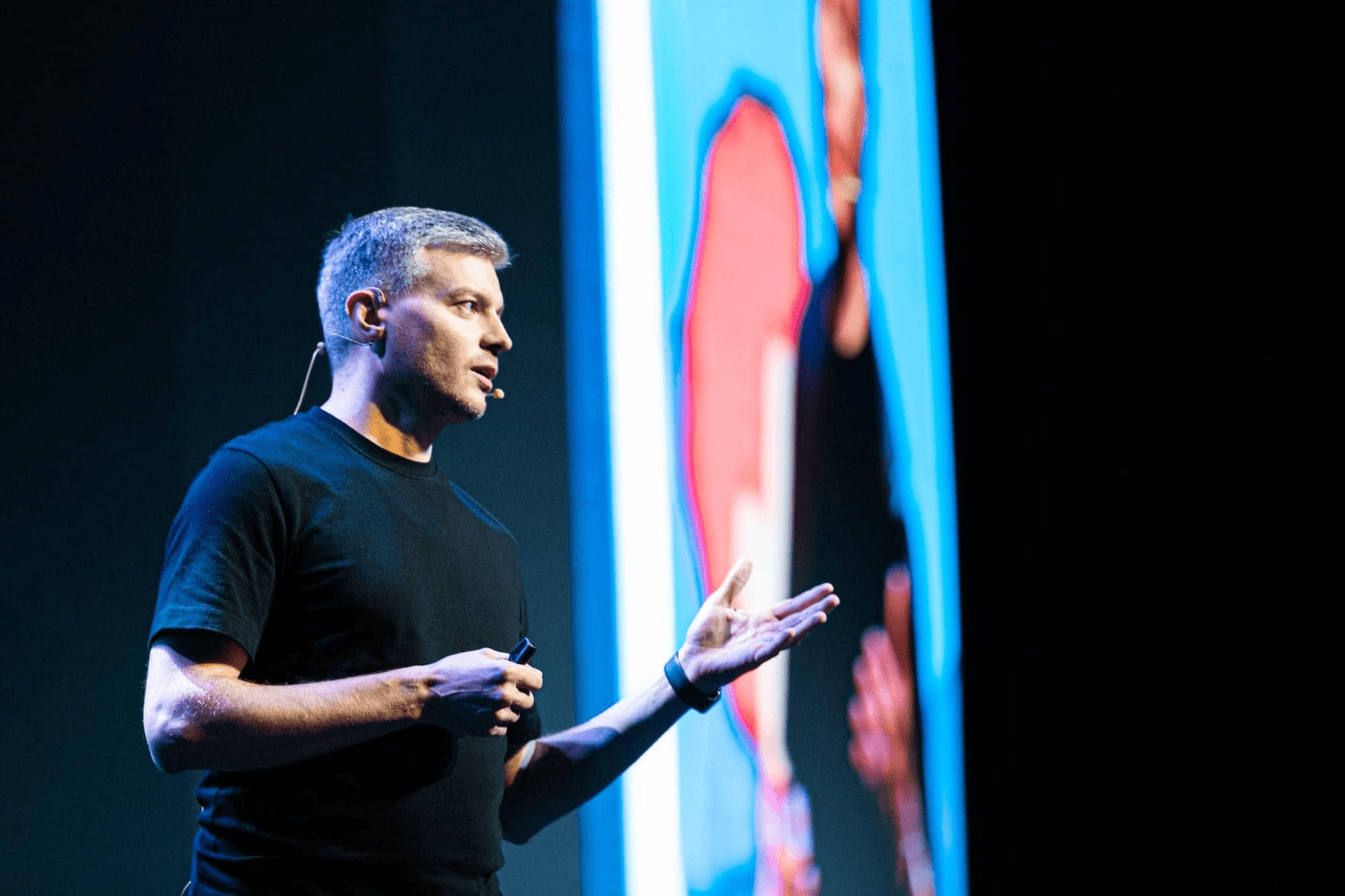 Speaker presents onstage about logistics innovation at a transportation industry conference.