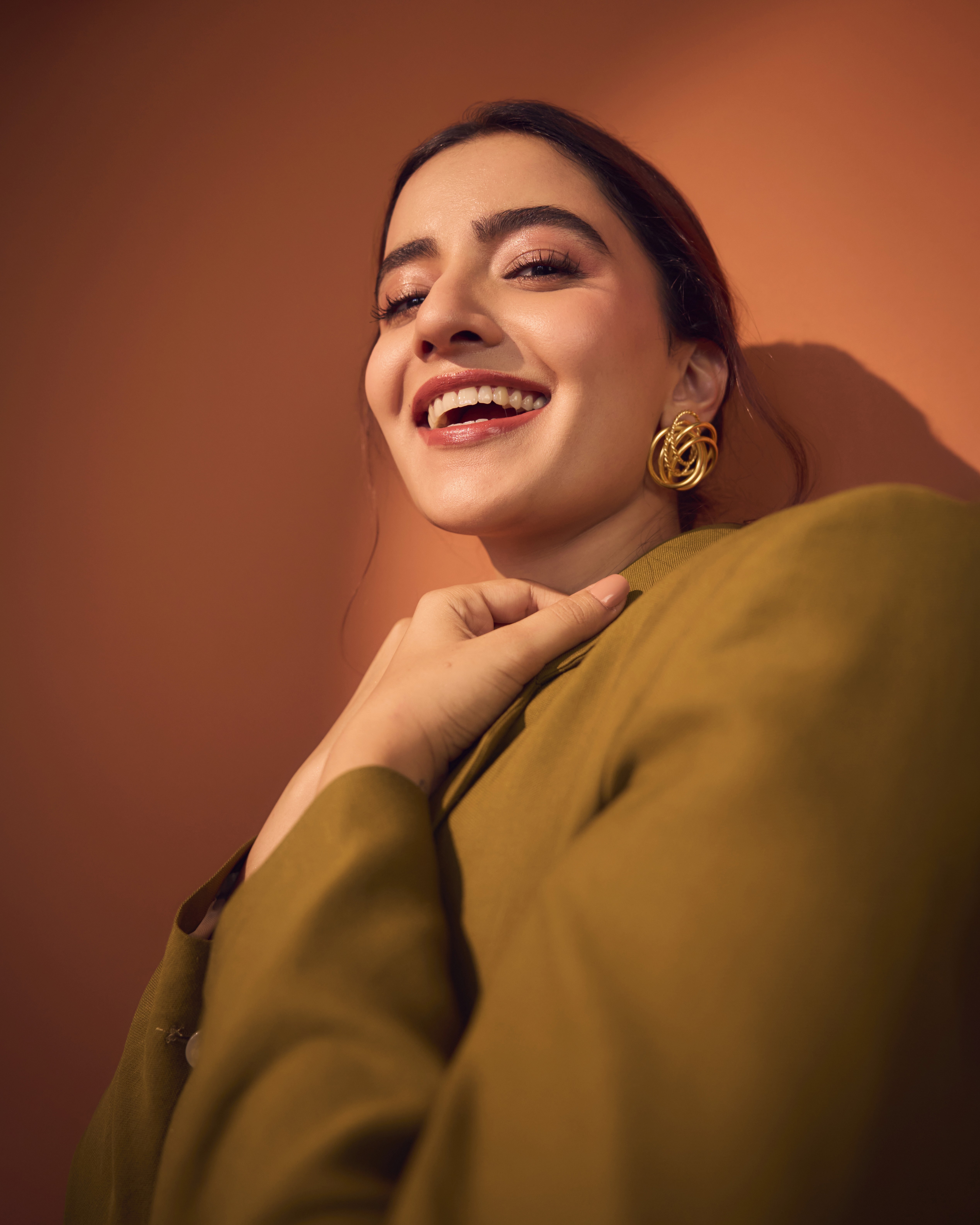 People playing soccer on a rooftop court surrounded by city buildings
