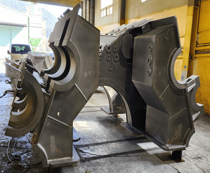 A person sits in a dimly lit, foggy room on a foldable chair, facing a large illuminated geometric shape. The scene conveys solitude and mystery