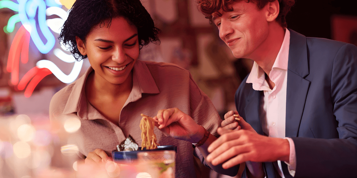 "Two professionals enjoy a meaningful connection over dinner, showcasing Soulmatch's focus on real-world experiences for lasting relationships."