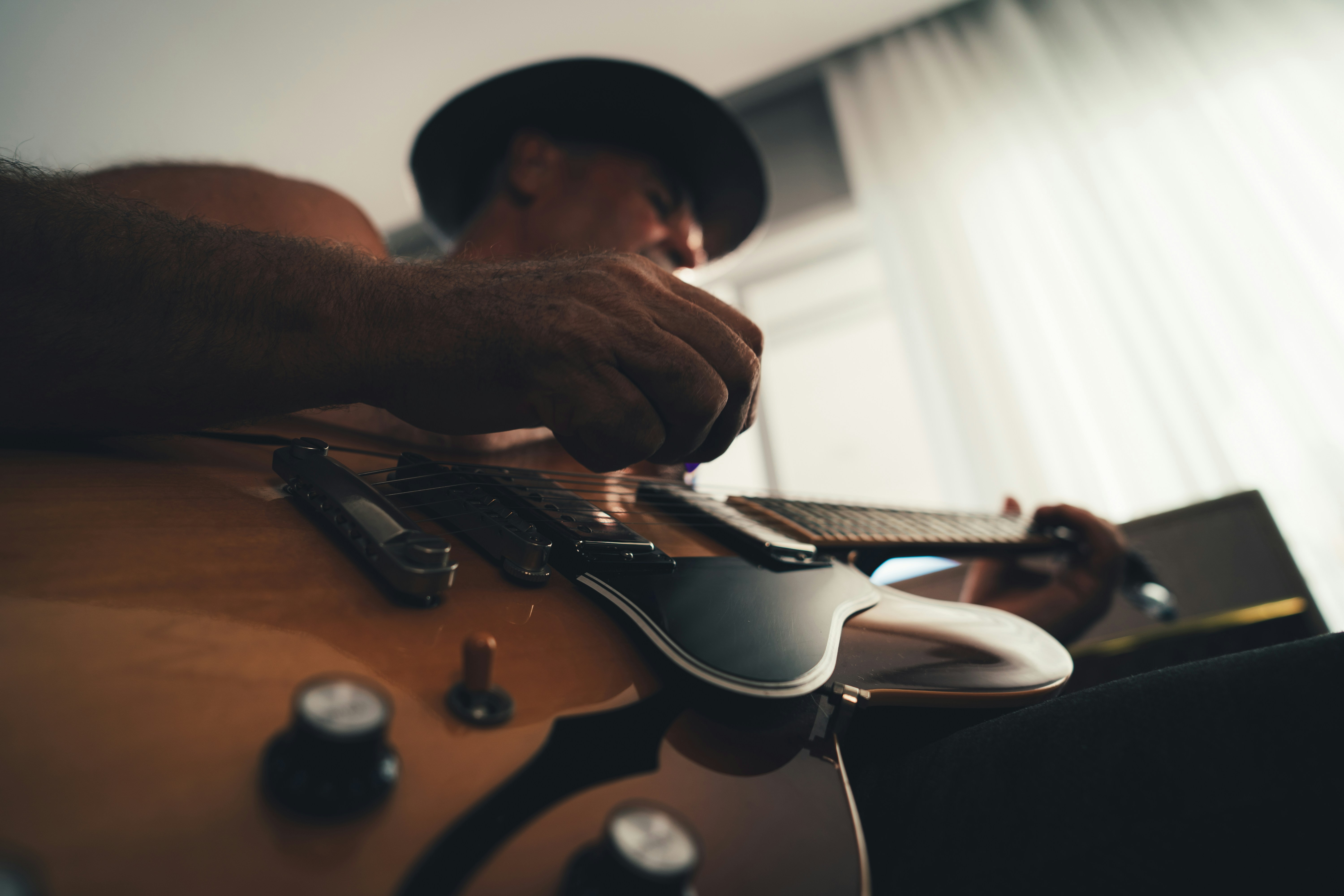 Man fretting a guitar