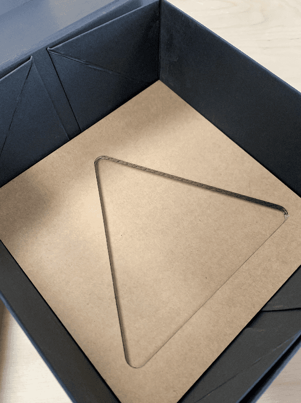 Image of cardboard inlays in a black cardboard box