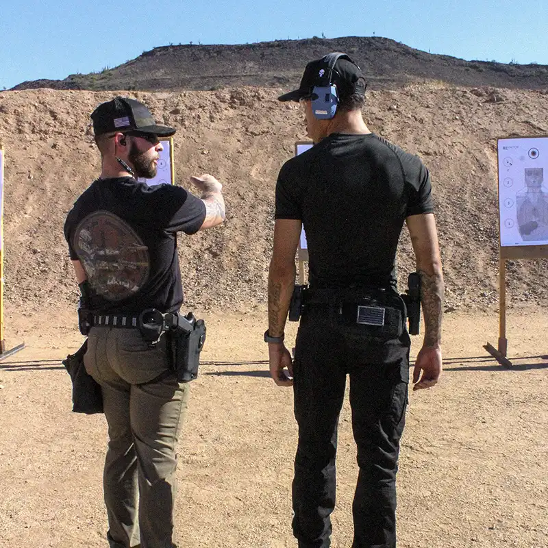 Tactical firearms training with instructor overseeing shooting exercise