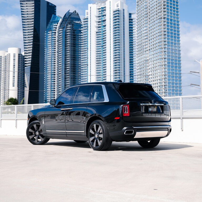Rear 3/4 view of a black Rolls-Royce Cullinan, showcasing its spacious rear and luxurious design.