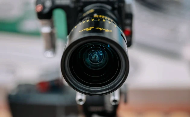 Close-up of a DZOFILM Arles zoom lens mounted on a cinema camera
