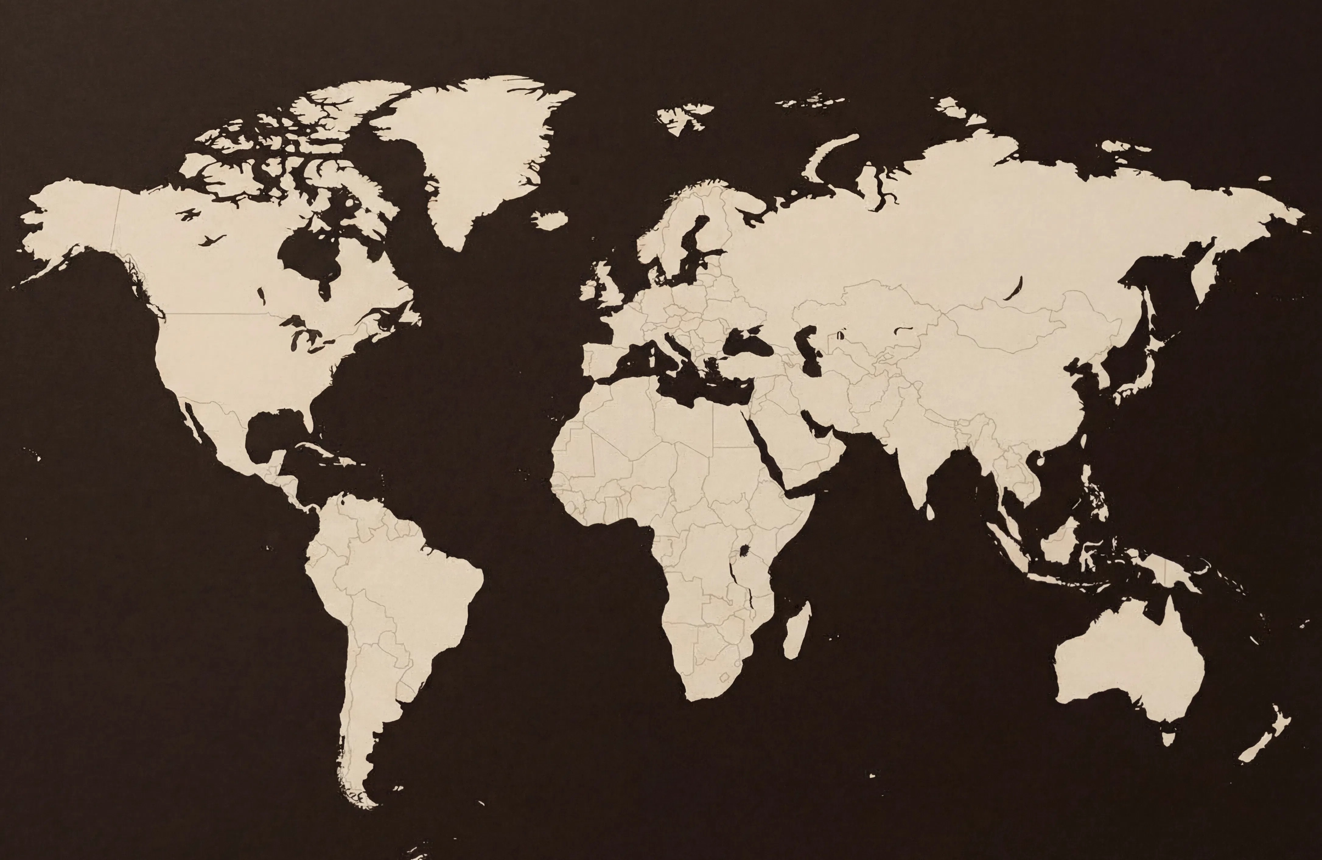 World map silhouette on a dark background, symbolizing global reach in luxury spirits packaging and premium bottle closures.