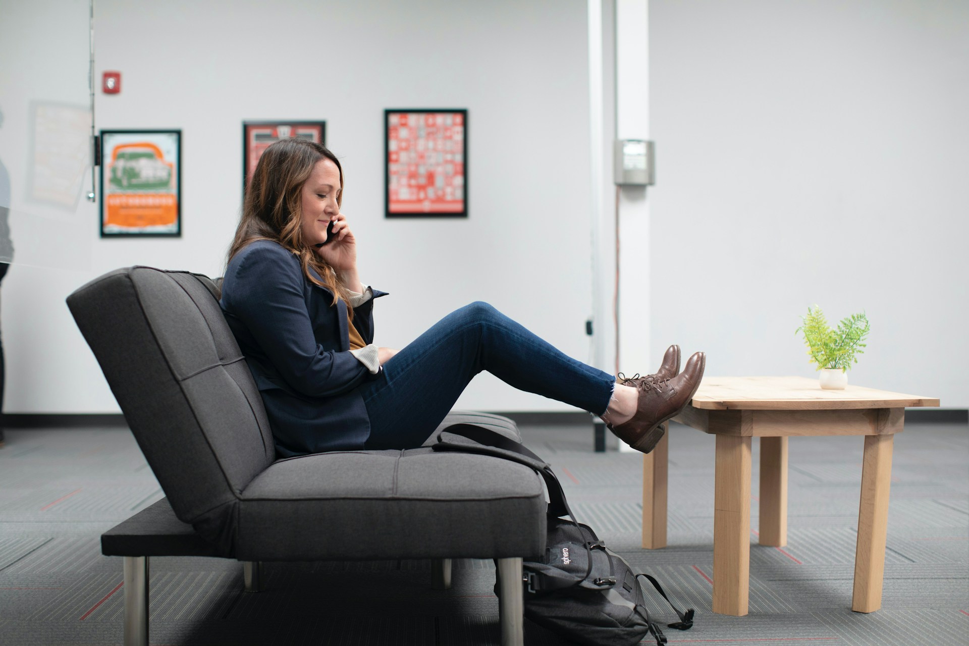 Sales woman relaxing on sofa couch during phone call