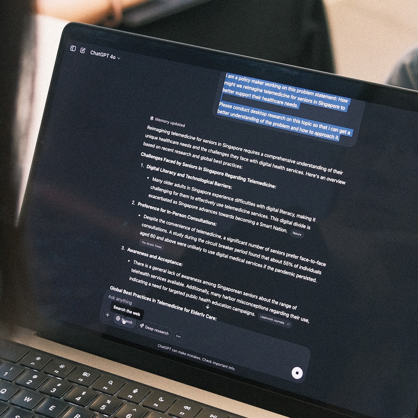 A zoom-in close up shot of a participant's Macbook featuring AI tool, ChatGPT.