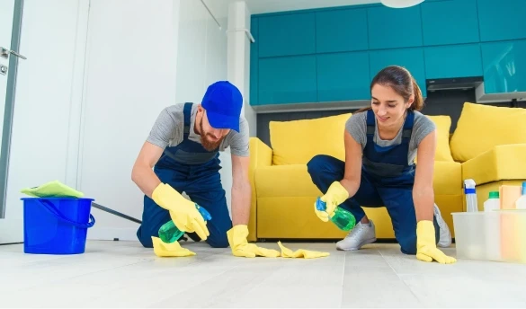 Two persons are cleaning the floor.