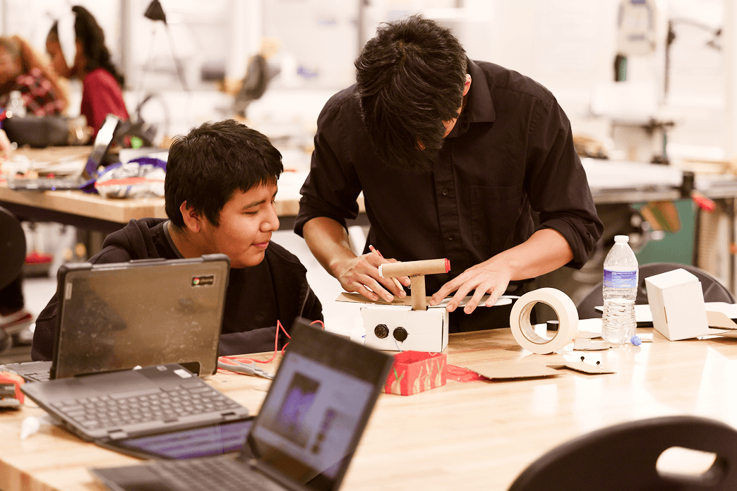 Two male highschool students designing their own video game at BlueSky Game Design challenge.