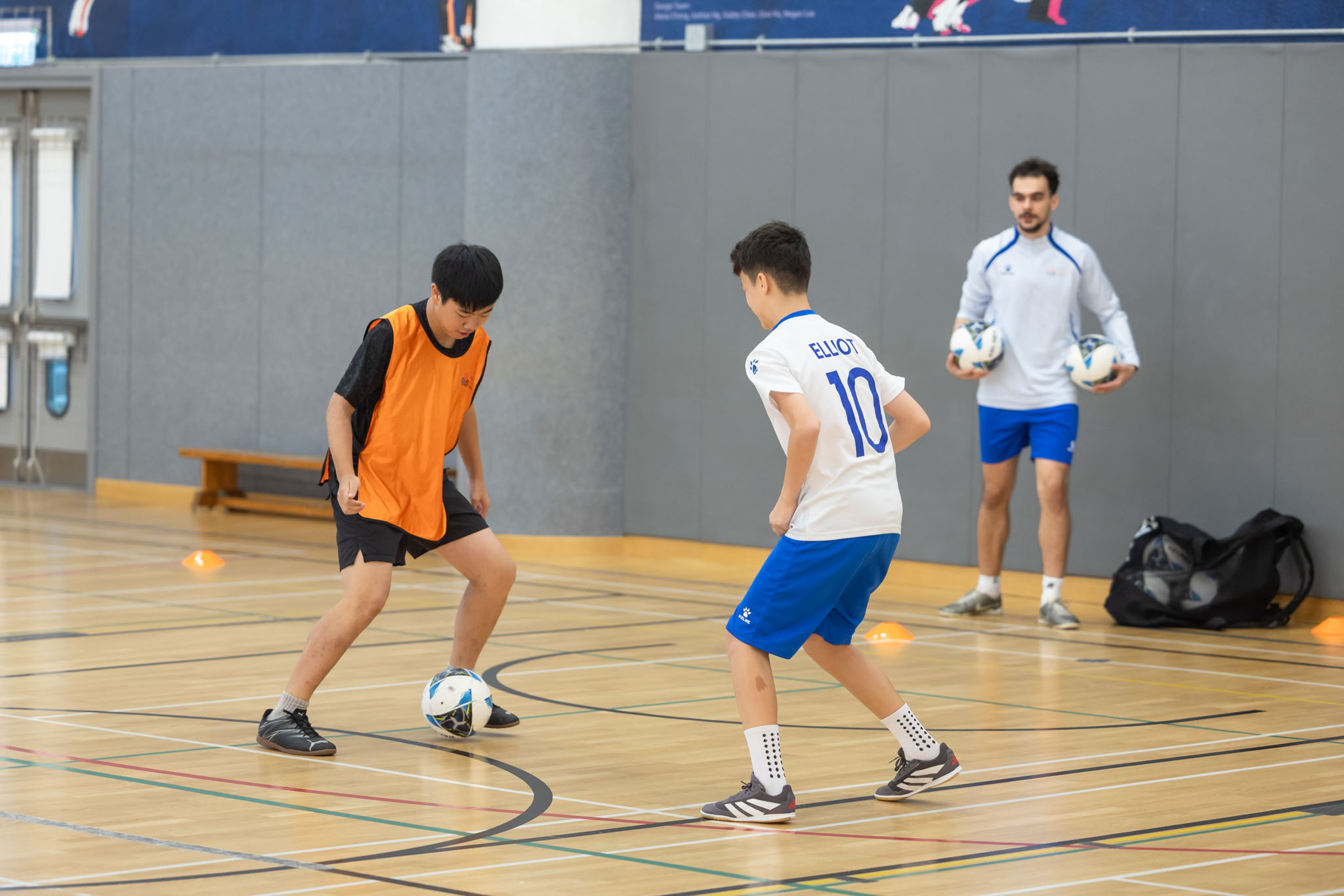 Football player weaving through cones