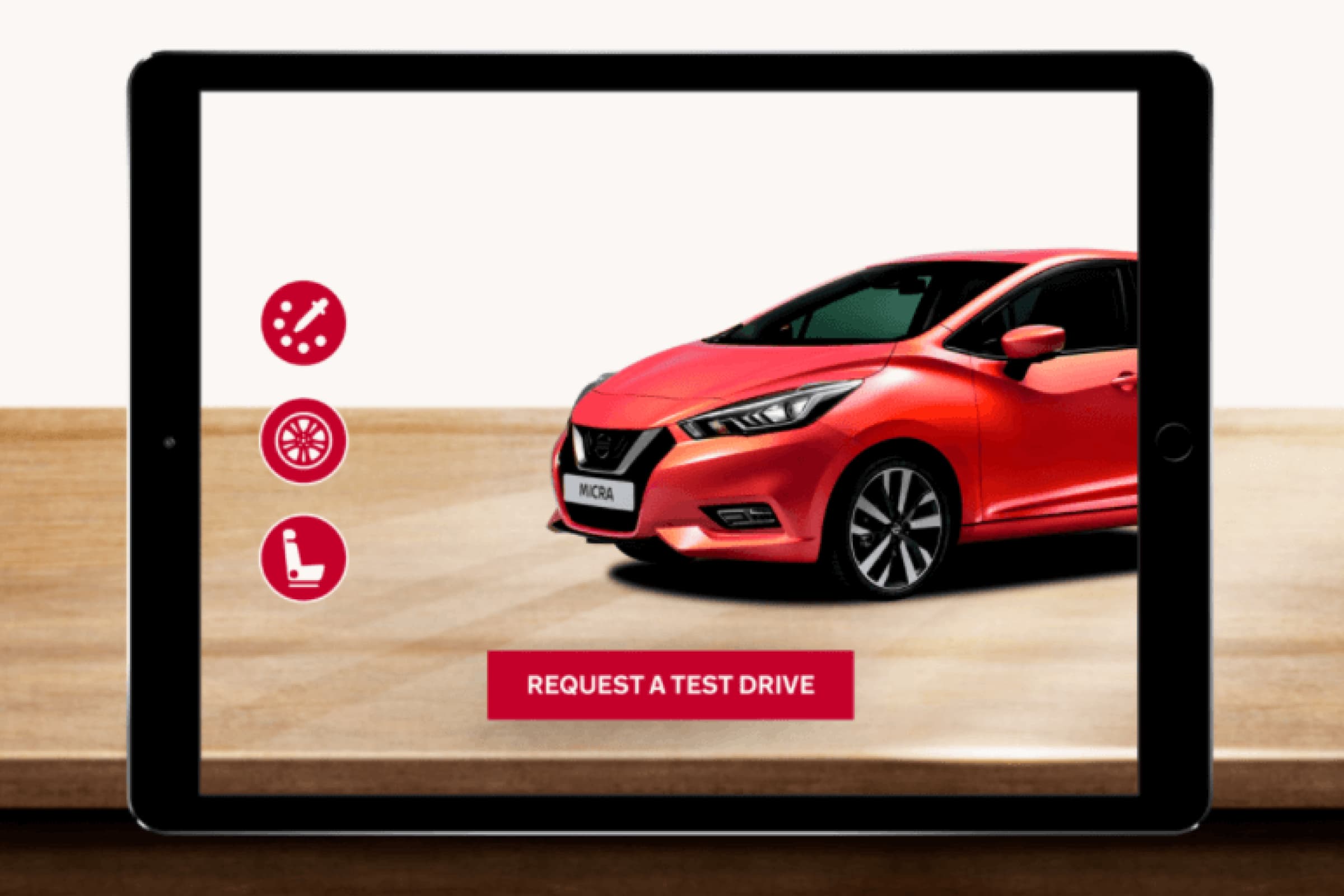 An ipad showing an AR application scanning a red car in the background