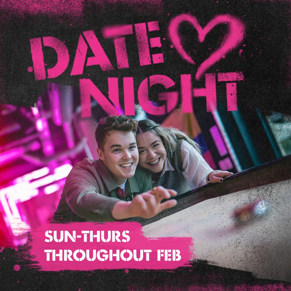 Couple on a date night playing a game. Promotion for date nights throughout February, Sunday-Thursday.