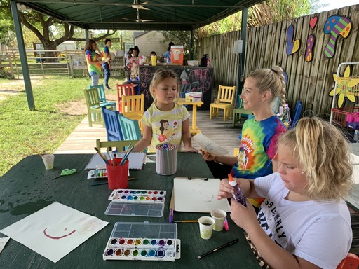 Children participating in grief support groups and an grief councelor painting with children at the Tomorrow's Rainbow mini-ranch