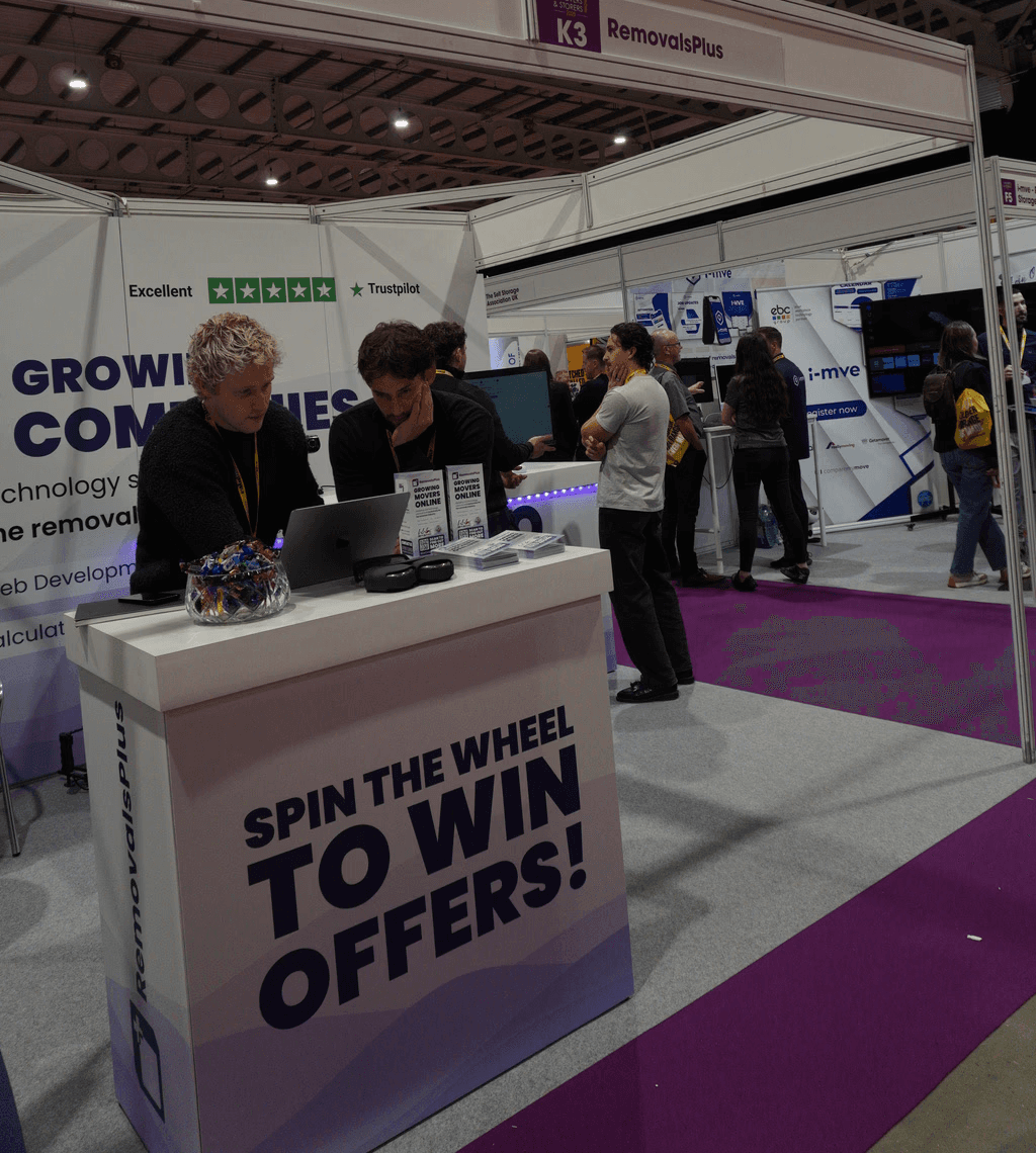 Three people sitting on a couch in a room looking at mobile devices