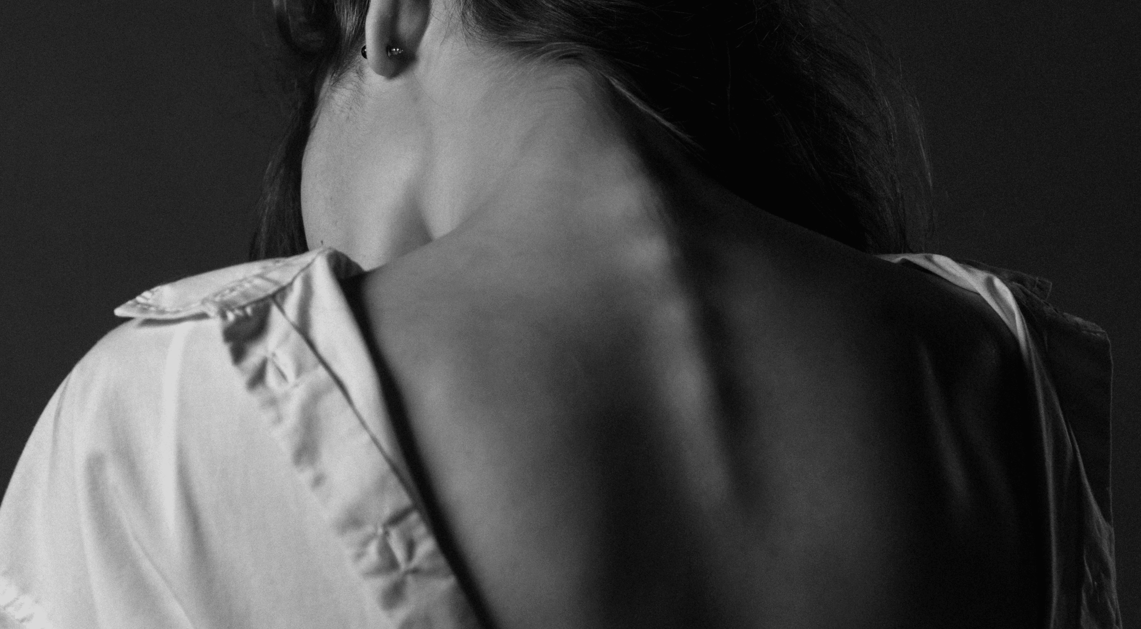 grayscale photo of woman in white button up shirt