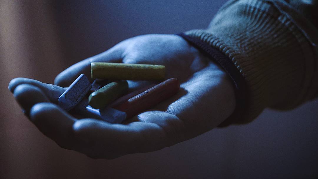 hand full of pills blue neon light