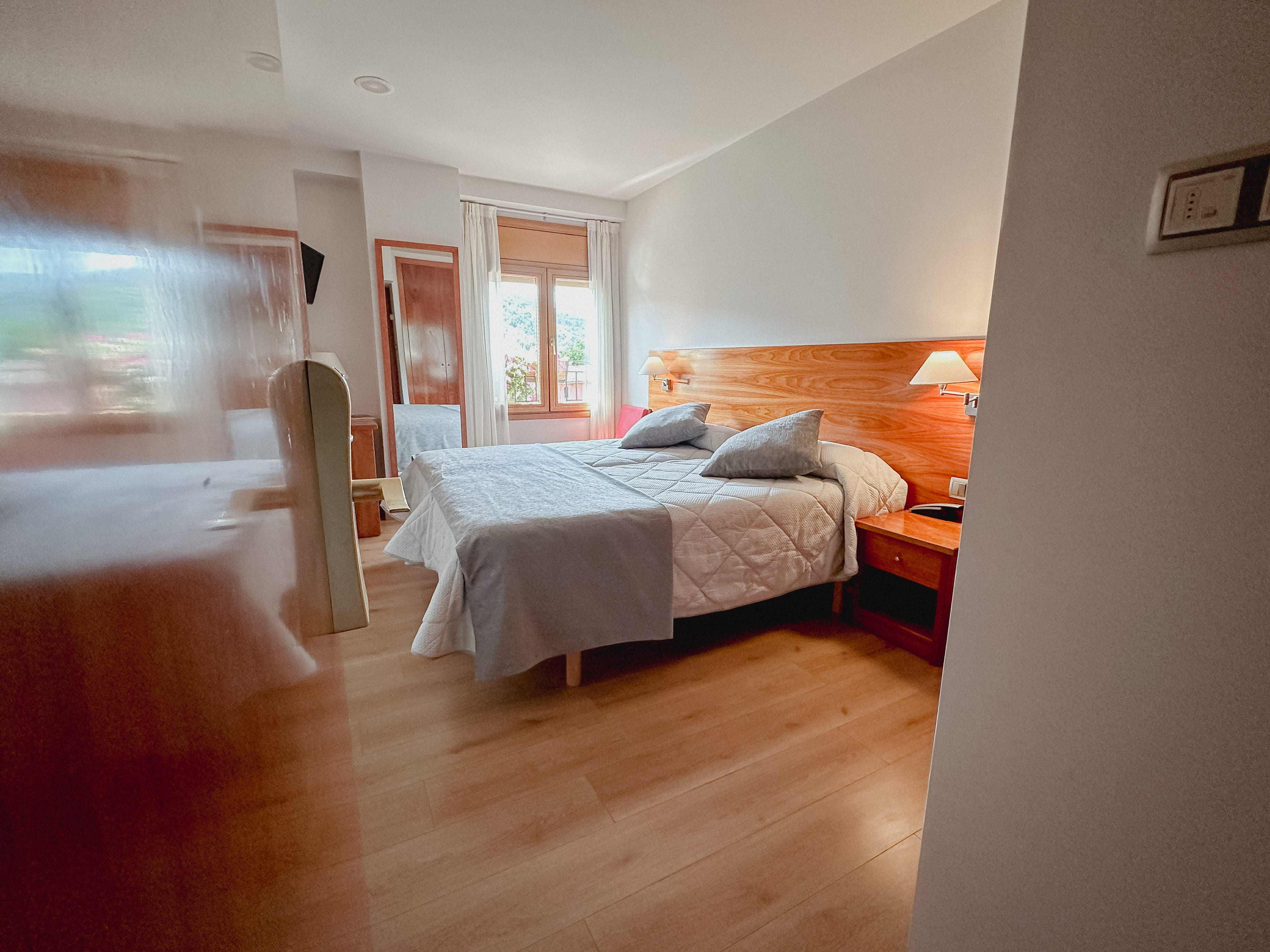classy bedroom with white rooms, beige bed and blur grey duvet