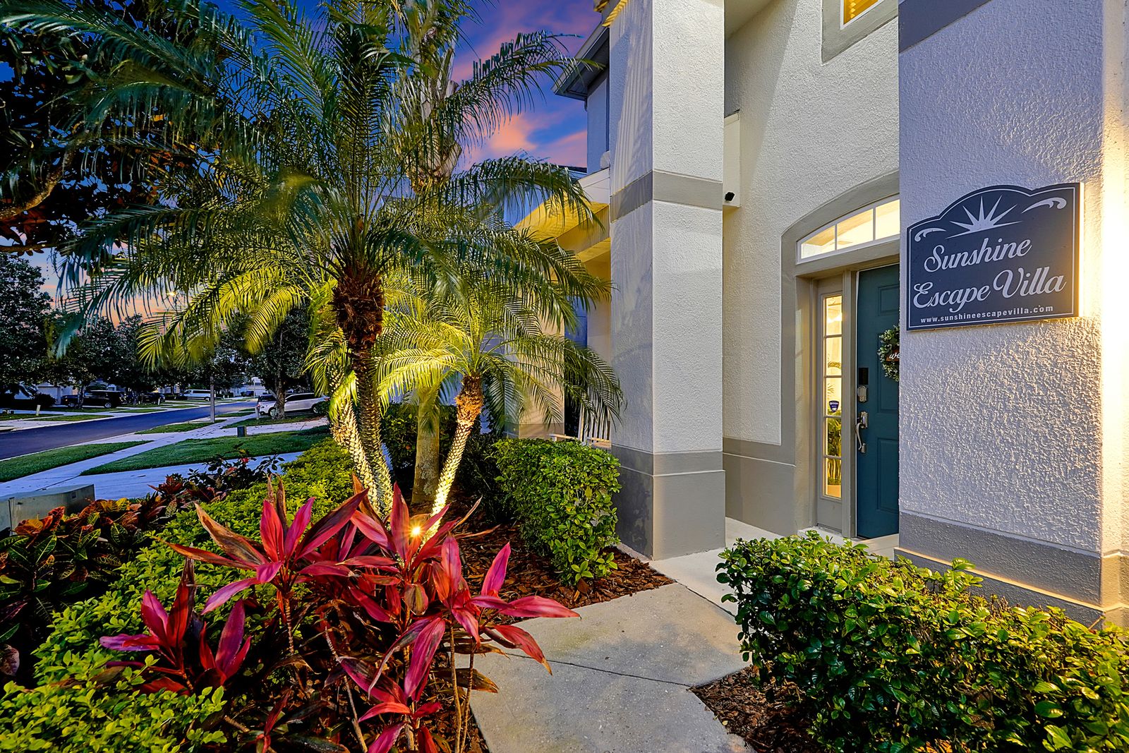 Elite villa with palm trees and signage