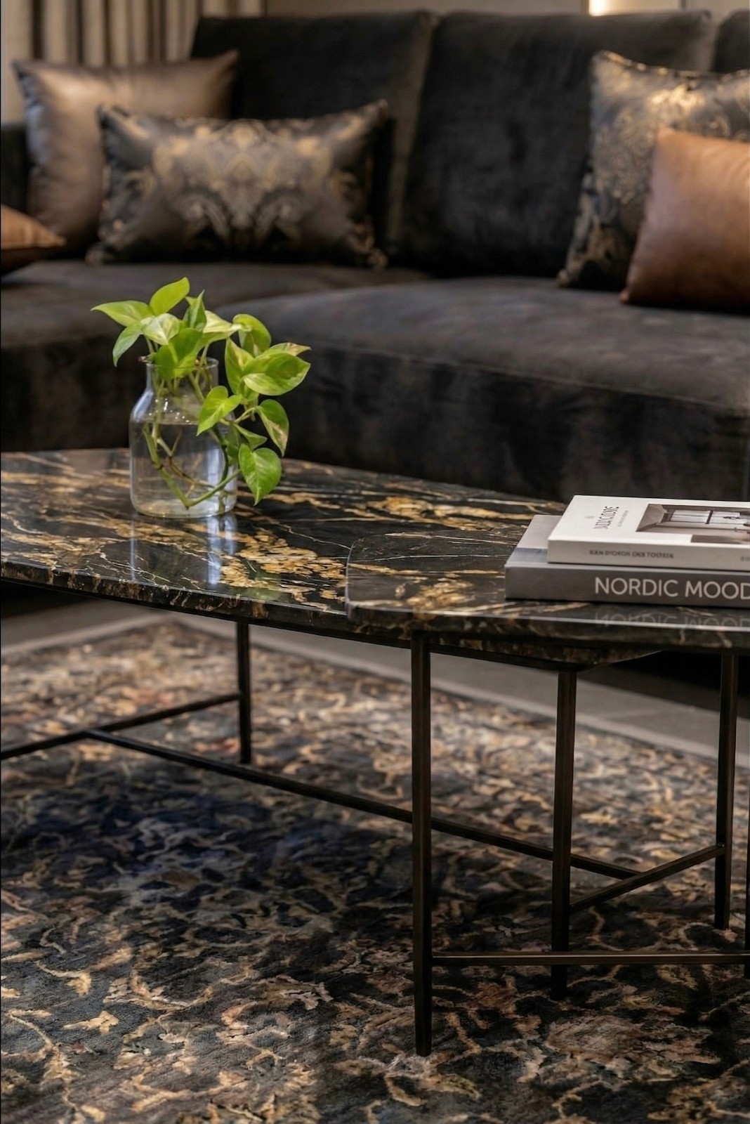 Vintage-modern living room with tufted sofas, false ceiling, and layered warm lighting.