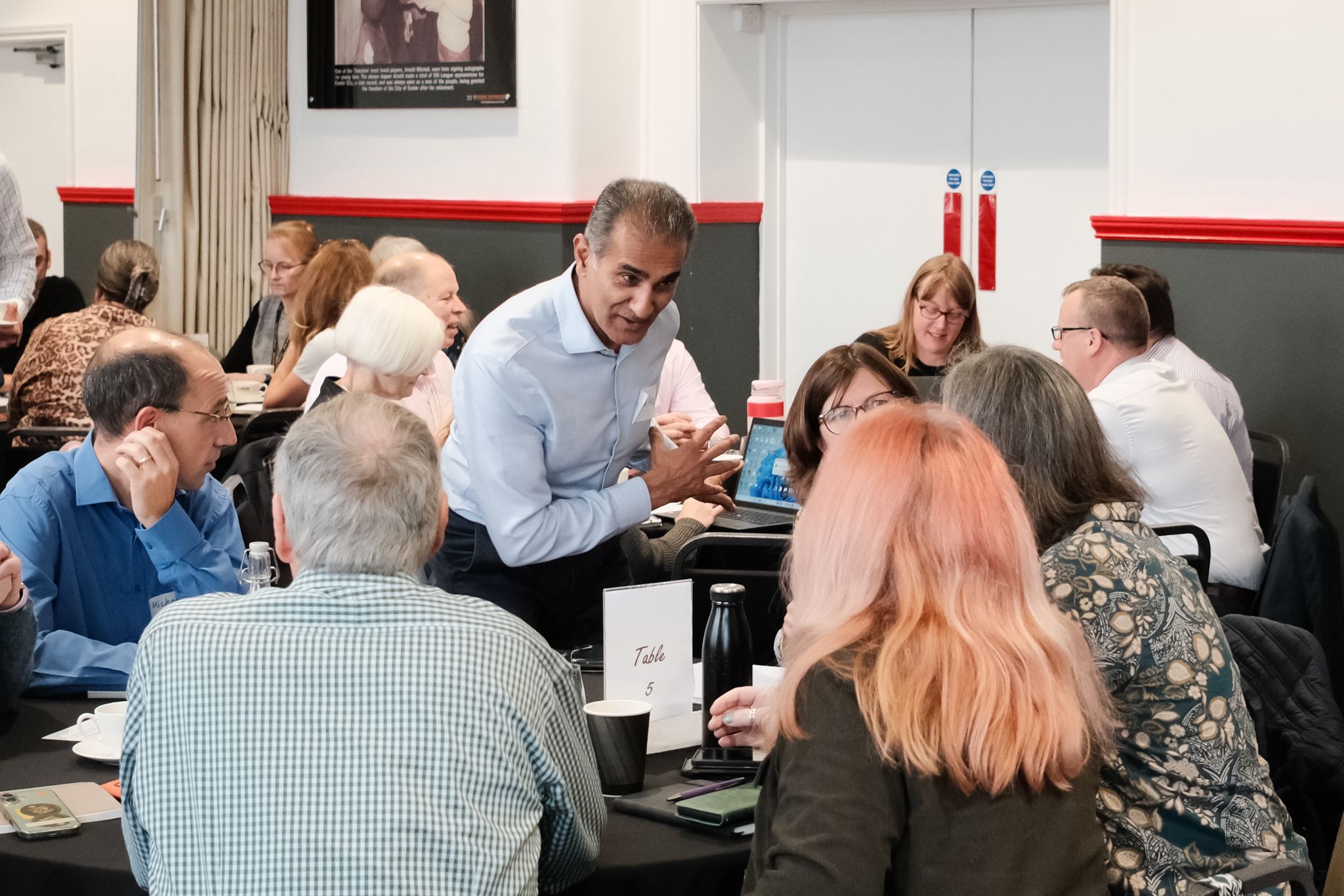 People gathered around a table in discussion