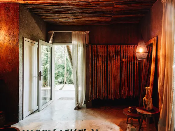 Jungle Room at Nômade Tulum featuring a lamp and huge window with stunning view.