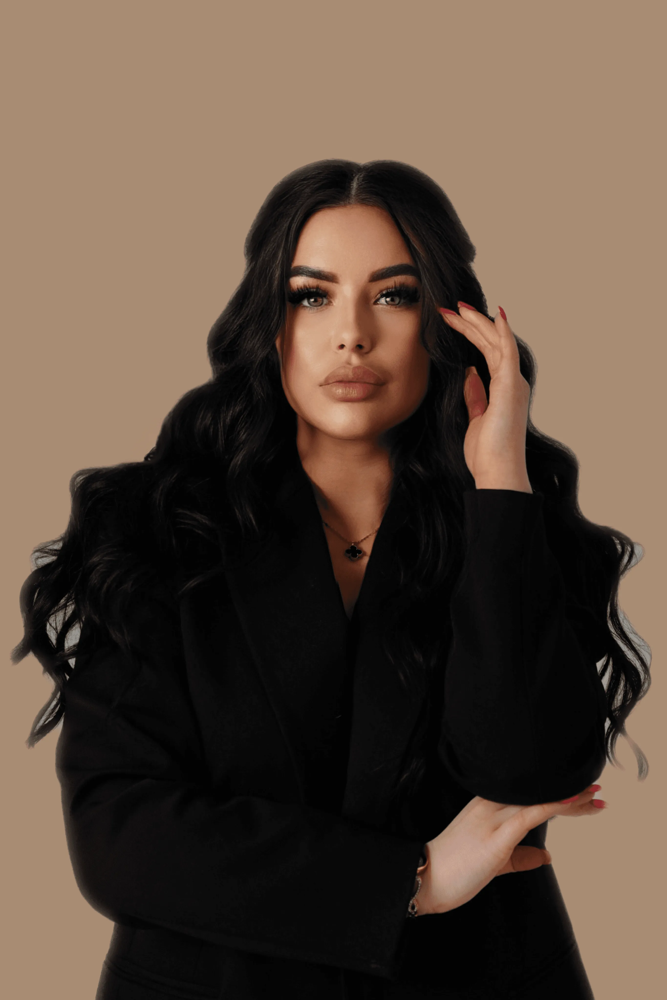 A person with short blonde hair holds a vintage camera.