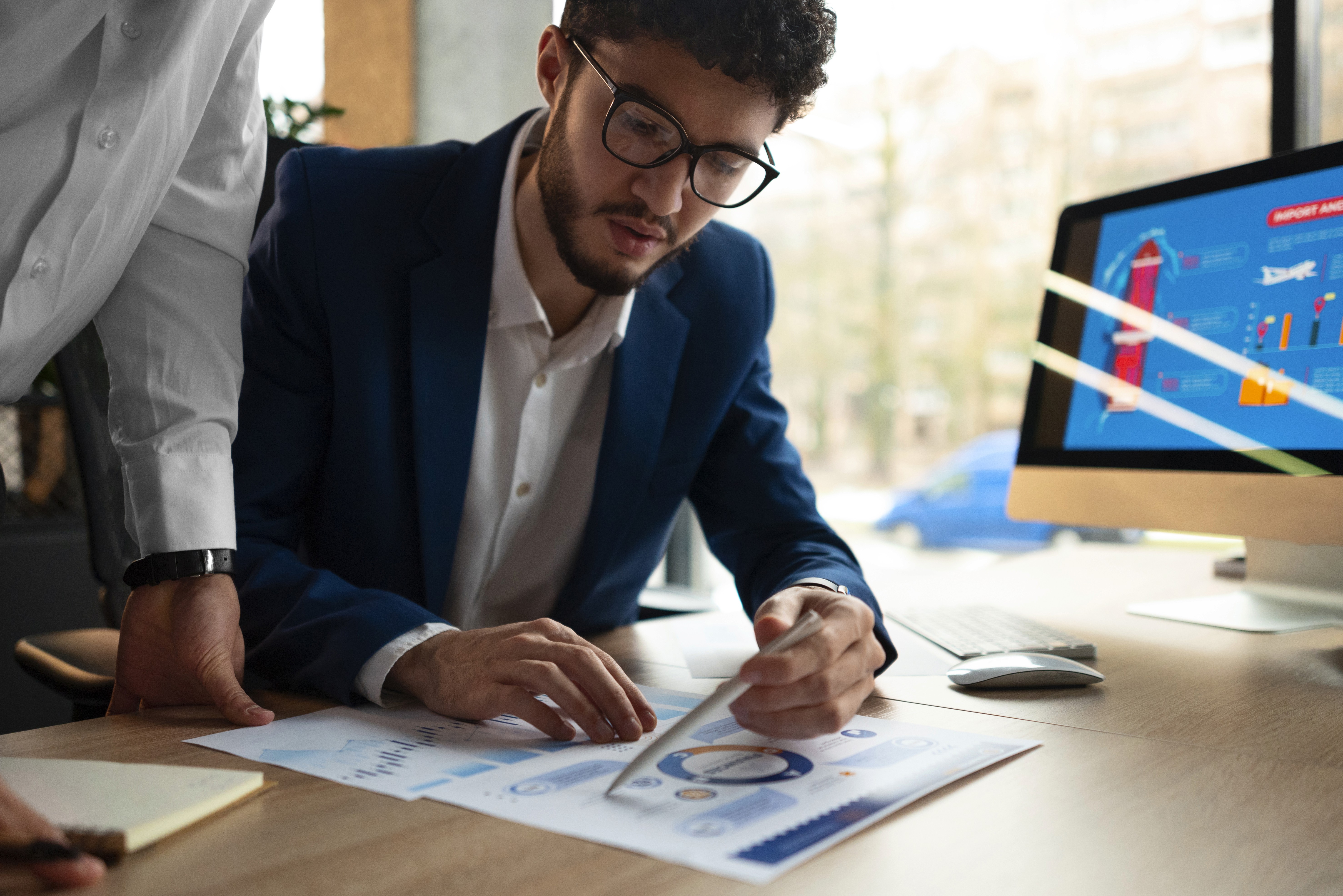 Professionals reviewing financial charts and performance metrics in an office setting, focused on data analysis, business strategy, and informed decision-making.