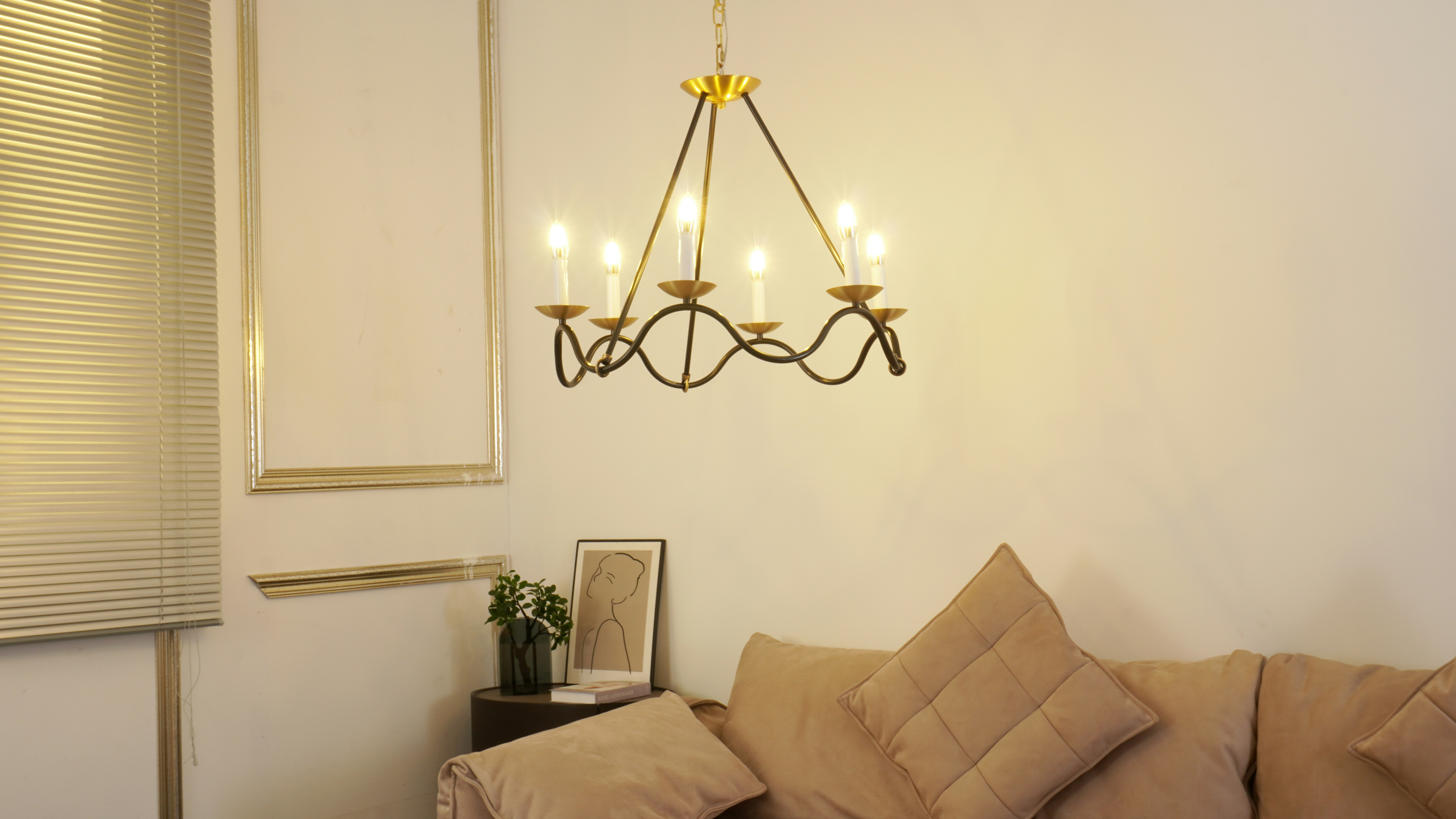 A vintage chandelier hangs above a sofa.