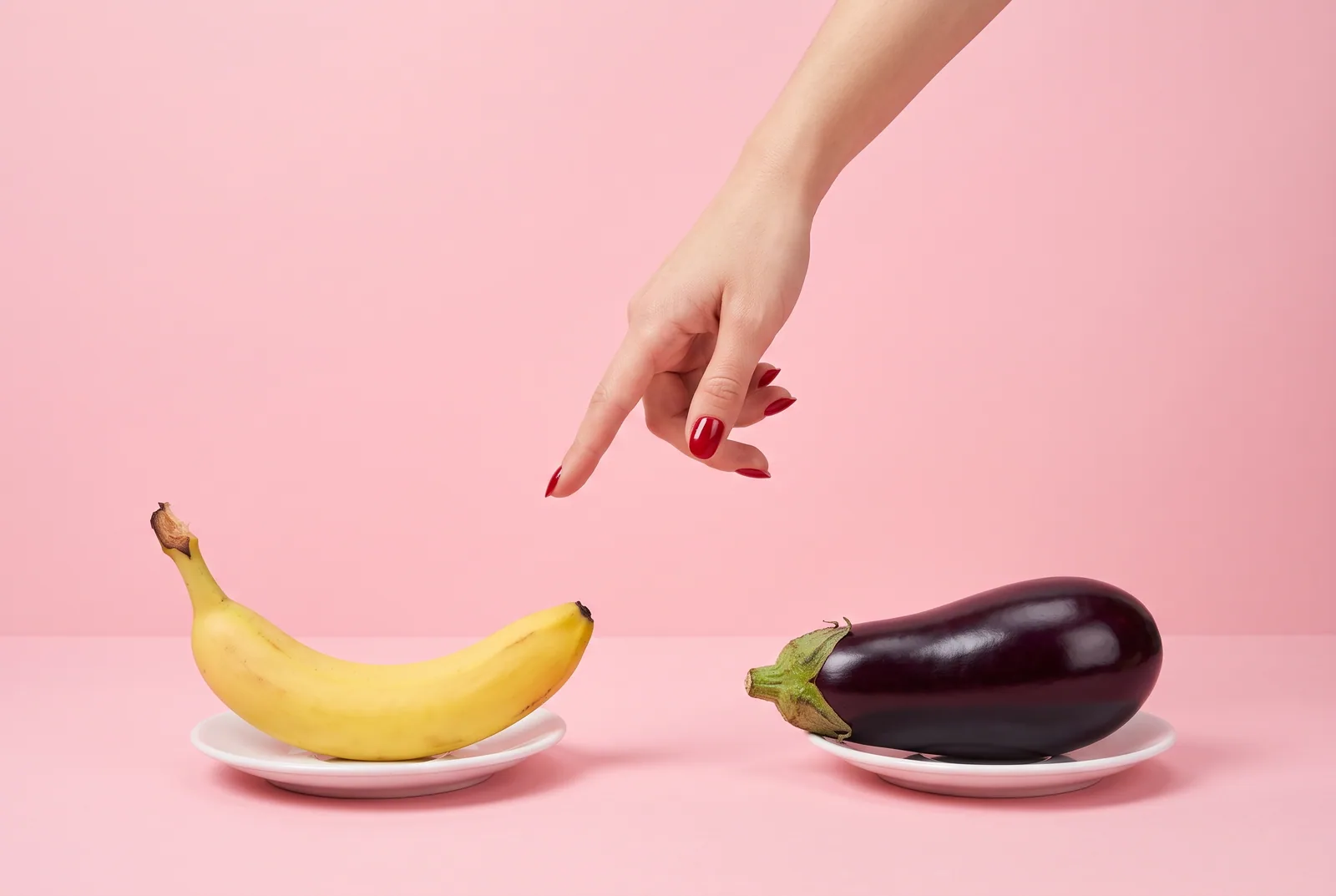 A hand hovering between a banana and an eggplant on two saucers, deciding Accountable2You vs Covenant Eyes