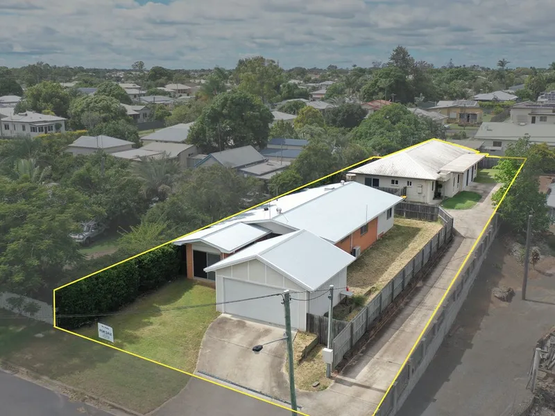 Two houses with yellow outline, aerial view.