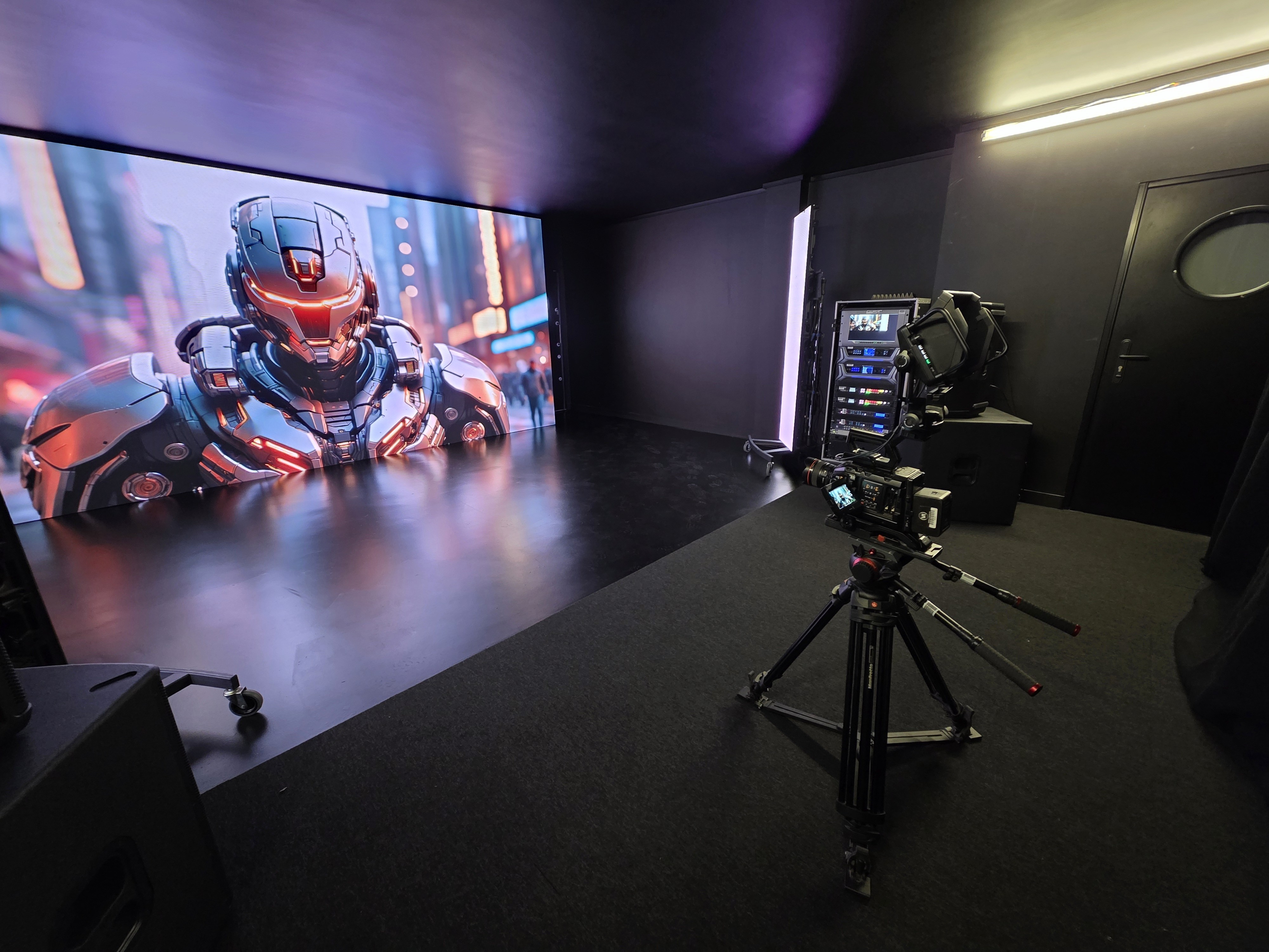 man in red shirt and black pants standing on stage